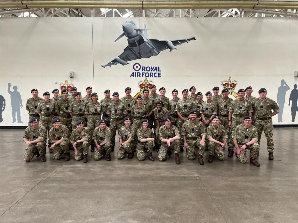 Personnel gather in a hangar.